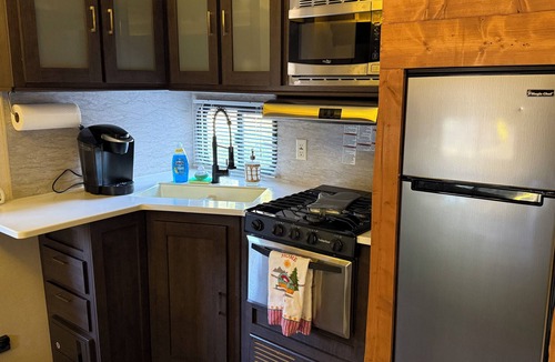 Jacob RV Rental | Camper in country setting beside water, near Burning Star Wildlife area