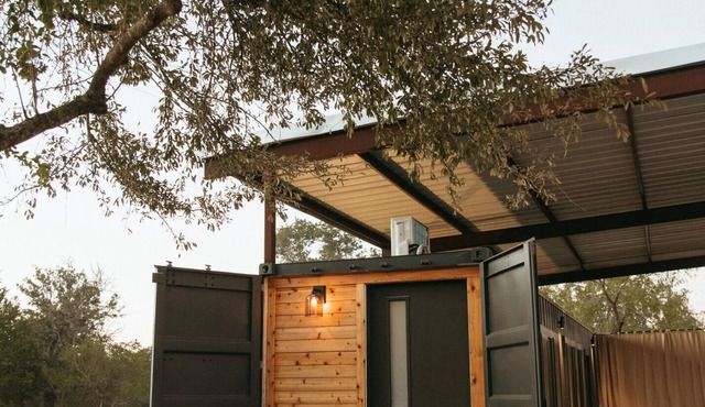 This home sits on a 45 acre, wooded retreat and event venue called Wild Roots Lockhart with tons of amenities including pickleball!